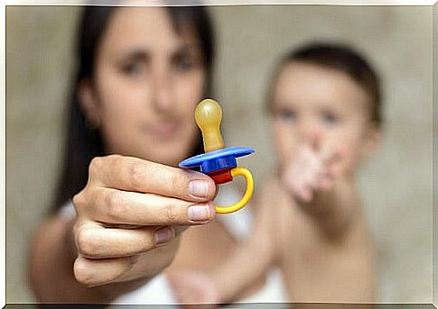 Mother helping her son to put down the pacifier.