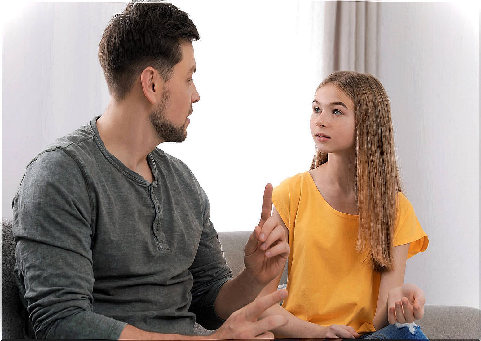 Father talking with his daughter about techniques for dealing with criticism in adolescence.