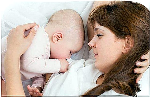 Baby suckling from his mother's breast and consuming lactose.