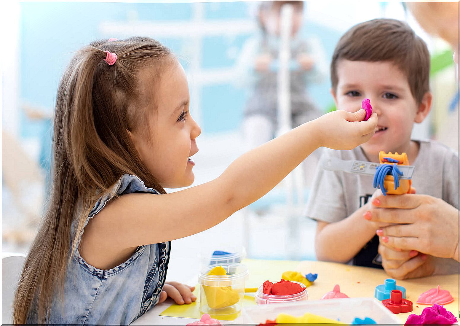 Child playing with plasticine doing sensory activities and crafts for agitated children.