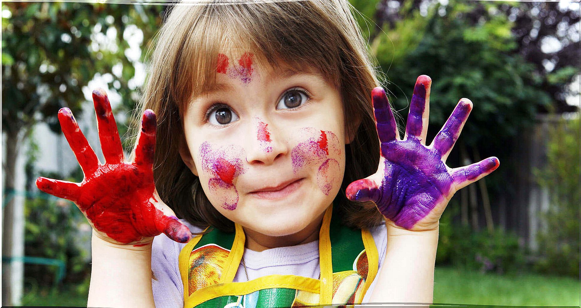 Girl enduring boredom developing her creativity by painting with her hands.