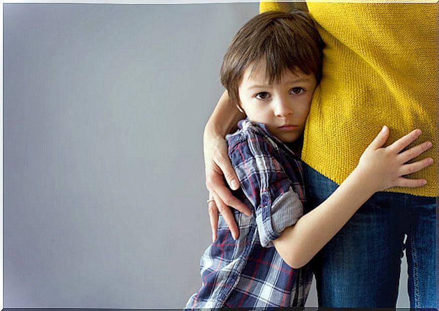 Boy very shyly hugged his mother.