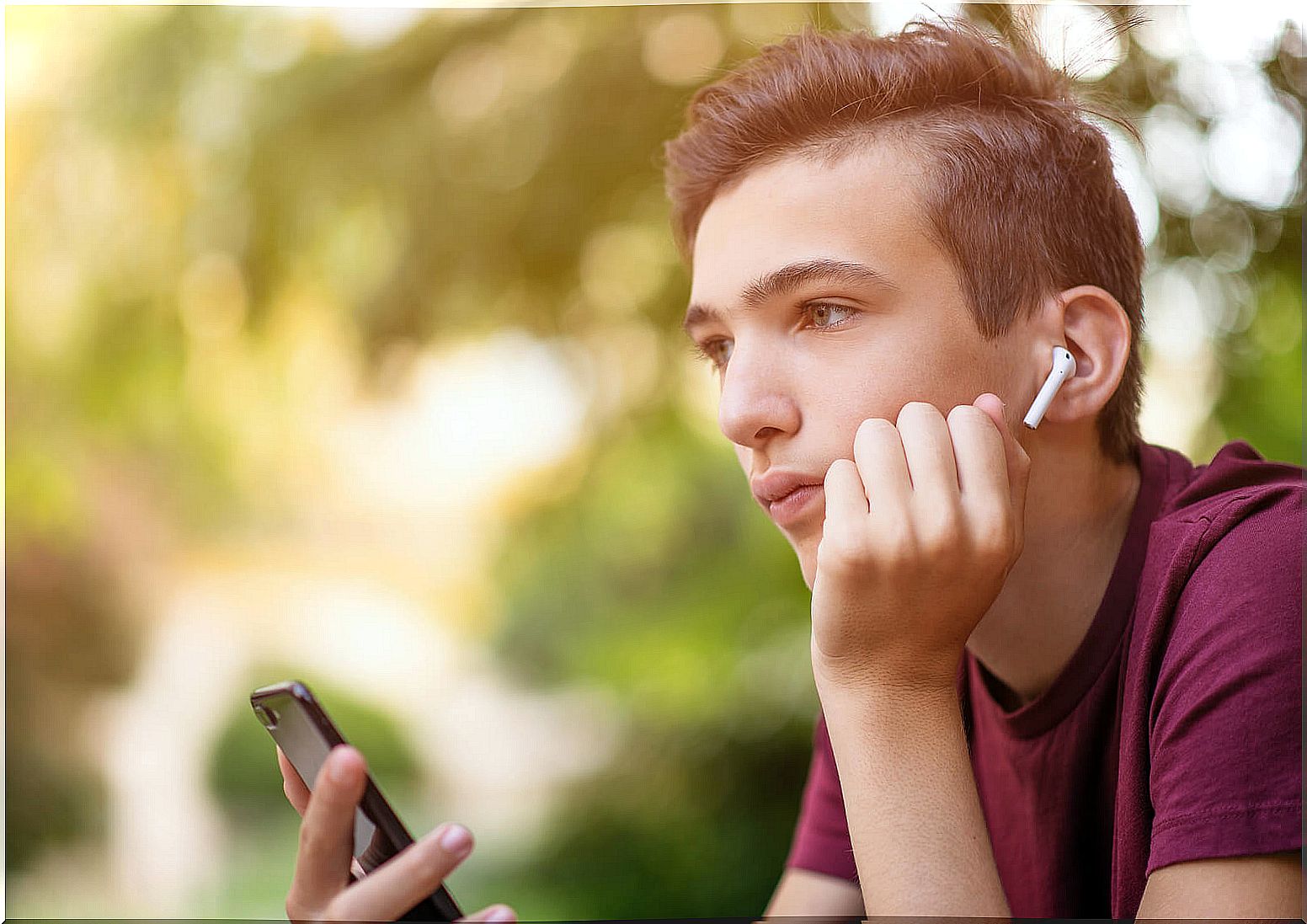 Teen boy listening to sad music.