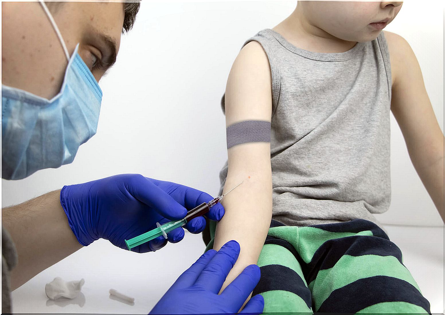 Doctor doing a blood test to a child with allergies.