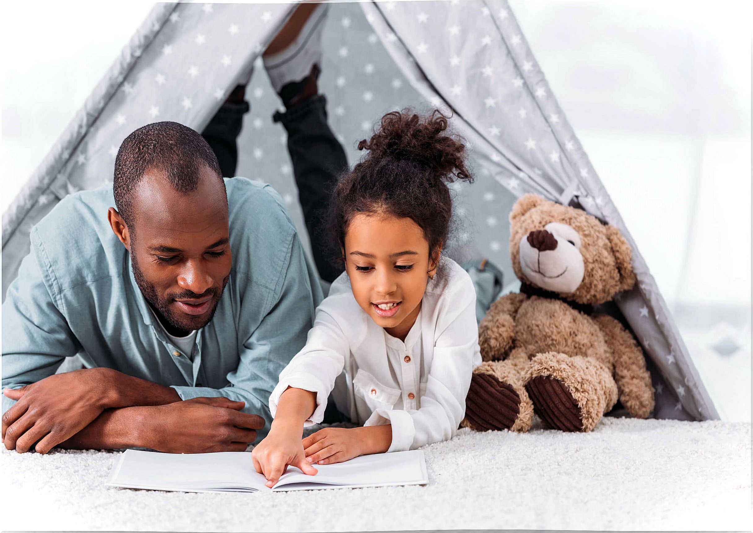 Mother with her daughter reading a story.