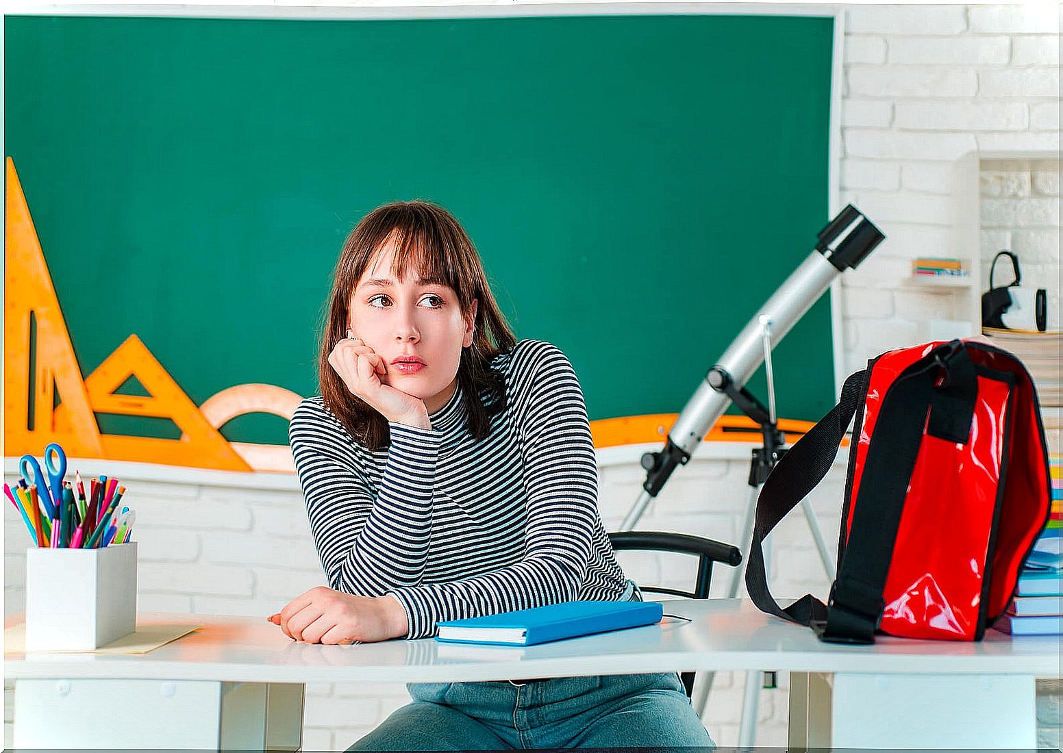 Teen girl thinking about how to choose her studies.