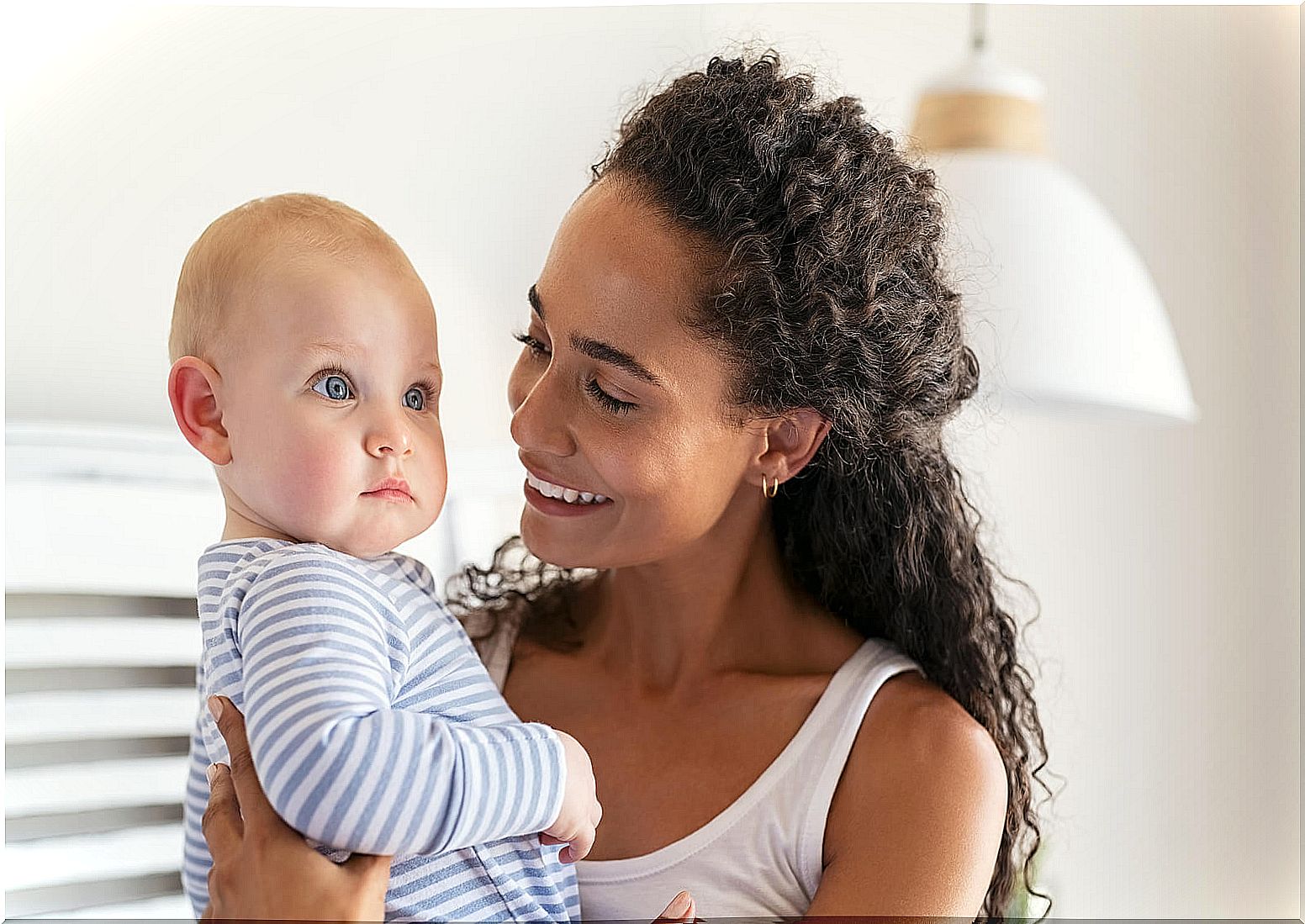 Mom with her baby smiling with happiness.