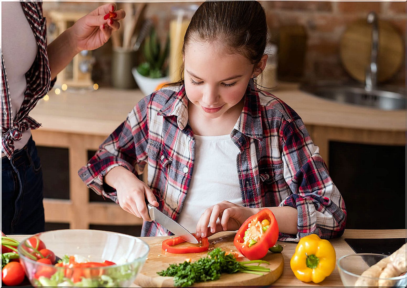 Little girl helping in the kitchen to increase the consumption of vegetables.