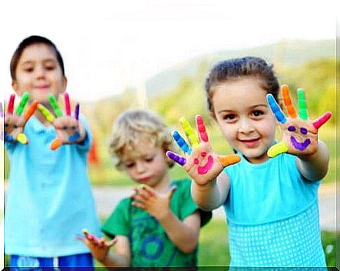 Children with paint on their hands to nurture their artistic talents.