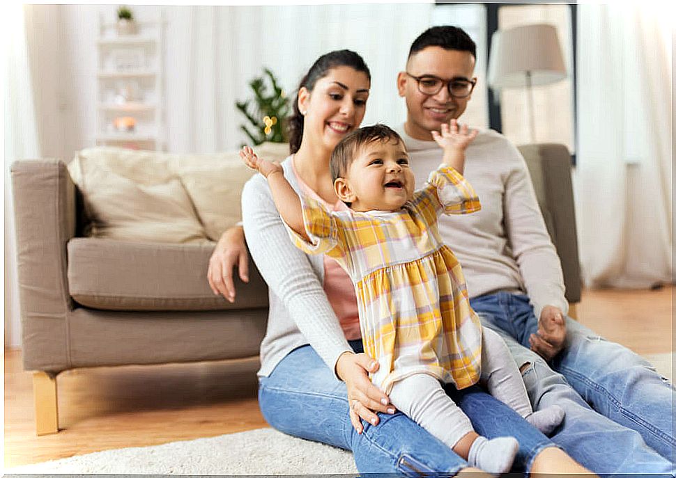 Family with their baby visiting friends.