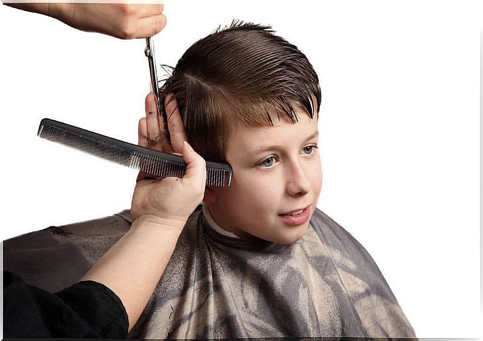 Boy cutting hair at the hairdresser