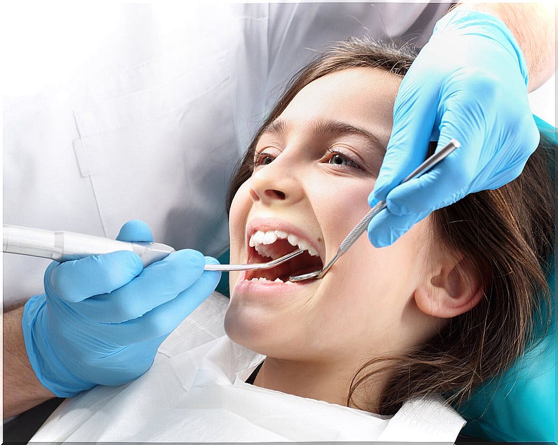 Little girl at the dentist to treat bruxism caused by stress.