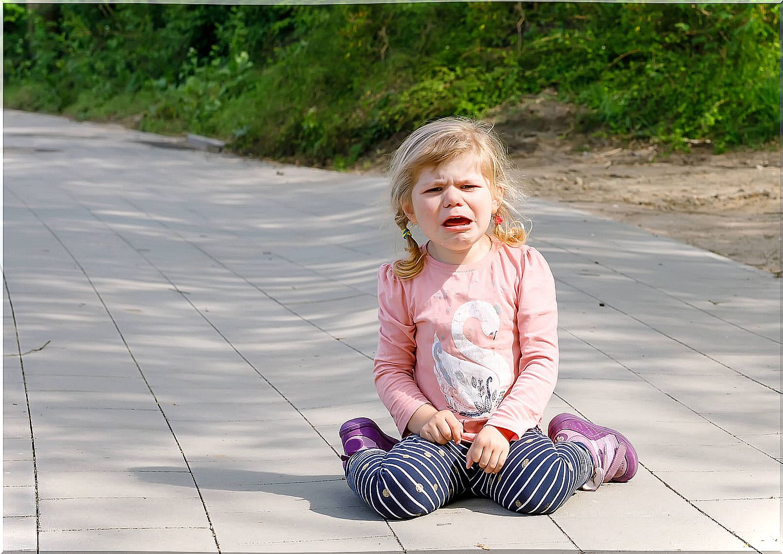 Little girl on the floor crying.