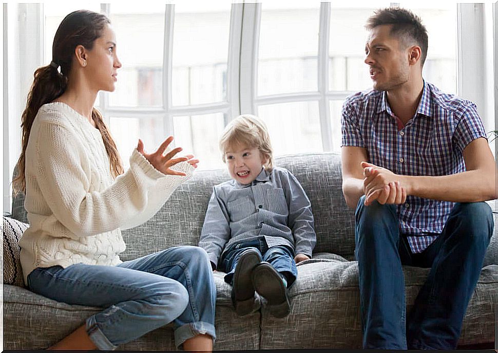 Parents arguing with their son in the middle.